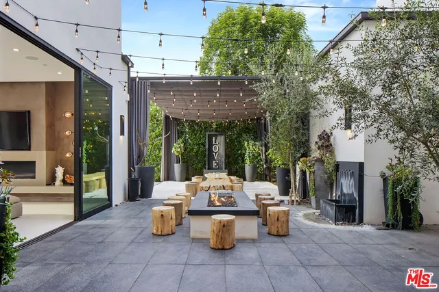 a view of a patio with dining table and chairs potted plants