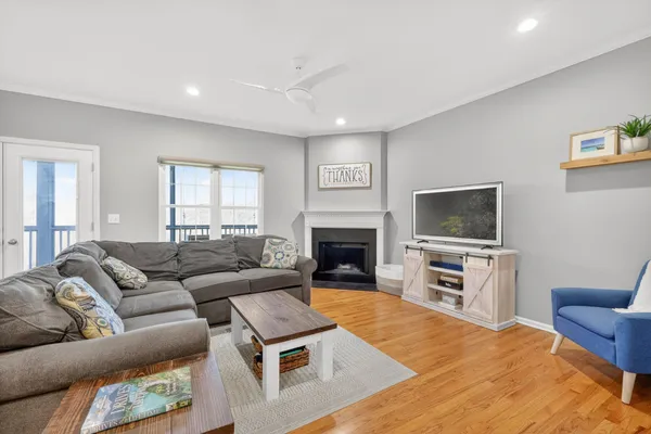 a living room with furniture a flat screen tv and a fireplace
