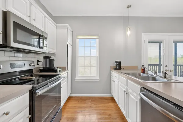 a kitchen that has a sink and a stove