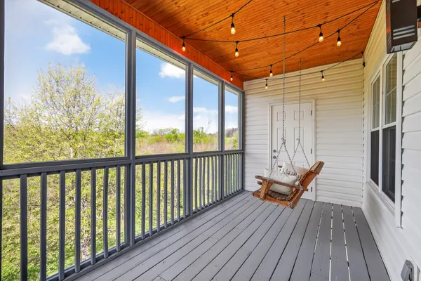 a view of balcony with wooden floor