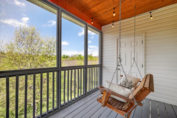 a view of a balcony with furniture