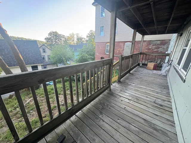 a view of balcony with wooden floor