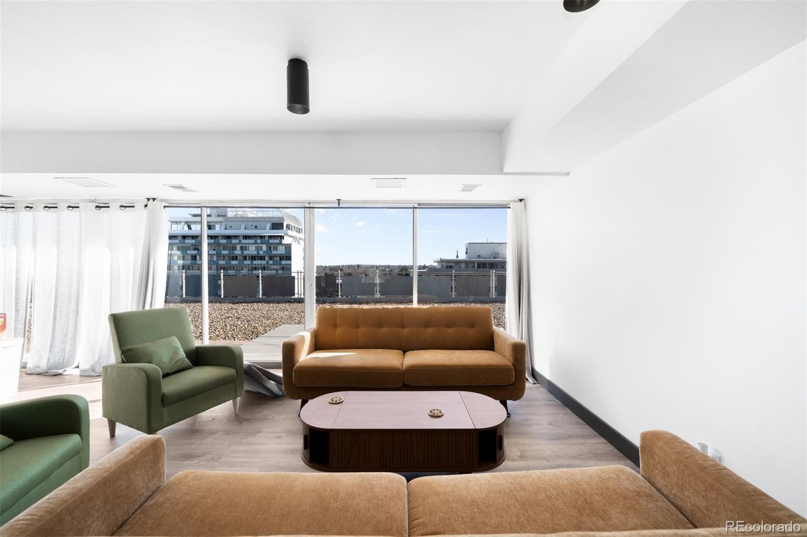 1121 Albion Street, Unit 704 Denver, CO 80220 - Photo 14 of 25 a living room with furniture and a large window