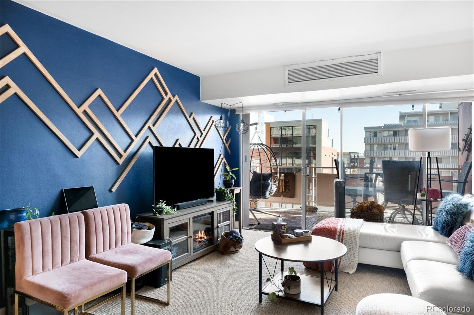 1121 Albion Street, Unit 704 Denver, CO 80220 - Photo 4 of 25 a living room with furniture and a flat screen tv