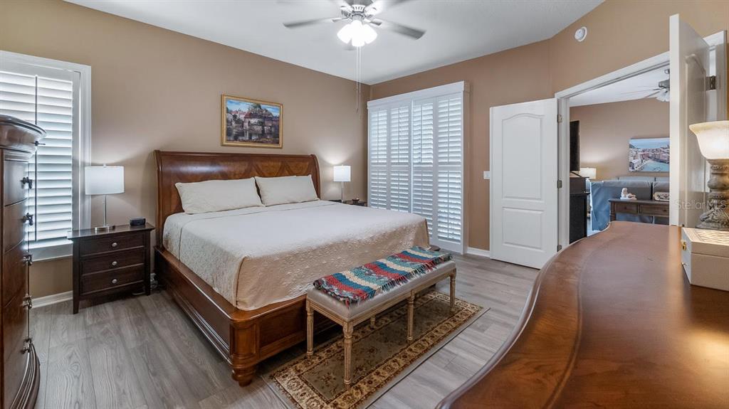 4232 Newland Street Clermont, FL 34711 - Photo 20 of 45 a bed room with a bed and a chandelier