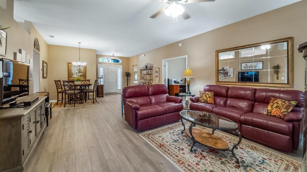 4232 Newland Street Clermont, FL 34711 - Photo 3 of 45 a living room with furniture and a flat screen tv