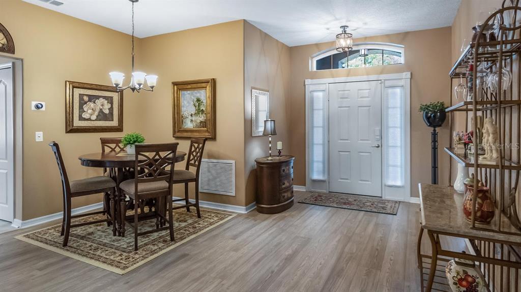 4232 Newland Street Clermont, FL 34711 - Photo 7 of 45 a view of a dining room with furniture window and wooden floor