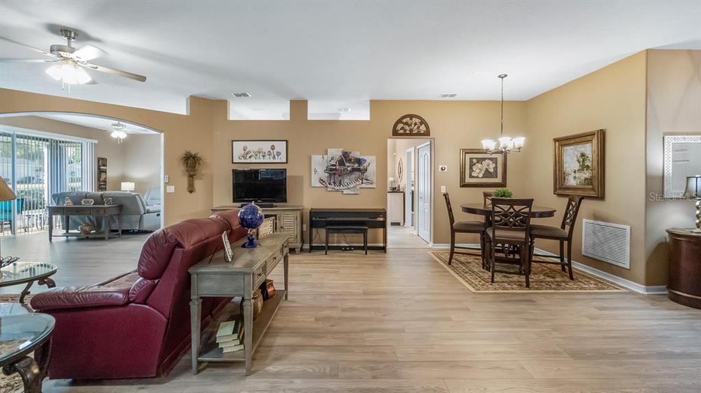 4232 Newland Street Clermont, FL 34711 - Photo 8 of 45 a living room with furniture and wooden floor