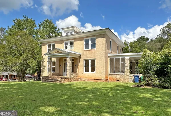a front view of a house with a garden