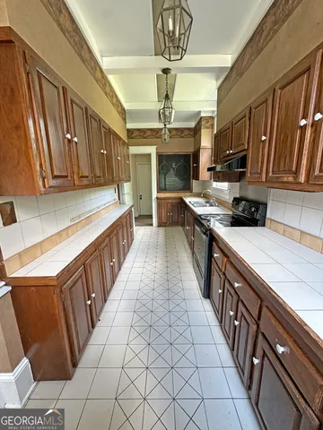 a kitchen with stainless steel appliances granite countertop a sink and cabinets