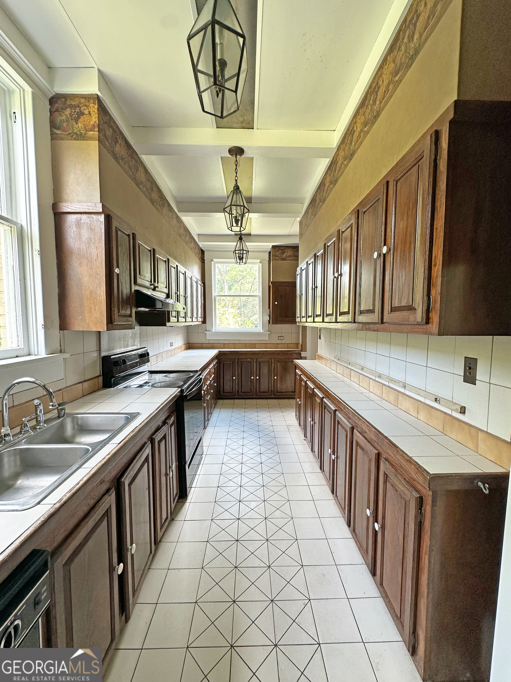 1010 Oglethorpe Avenue Athens, GA 30606 - Photo 13 of 28 a kitchen with stainless steel appliances a sink stove and cabinets