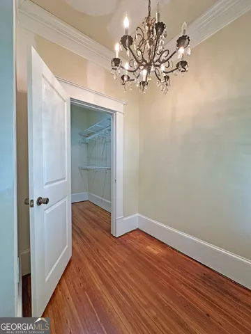 a view of entryway and hall with wooden floor