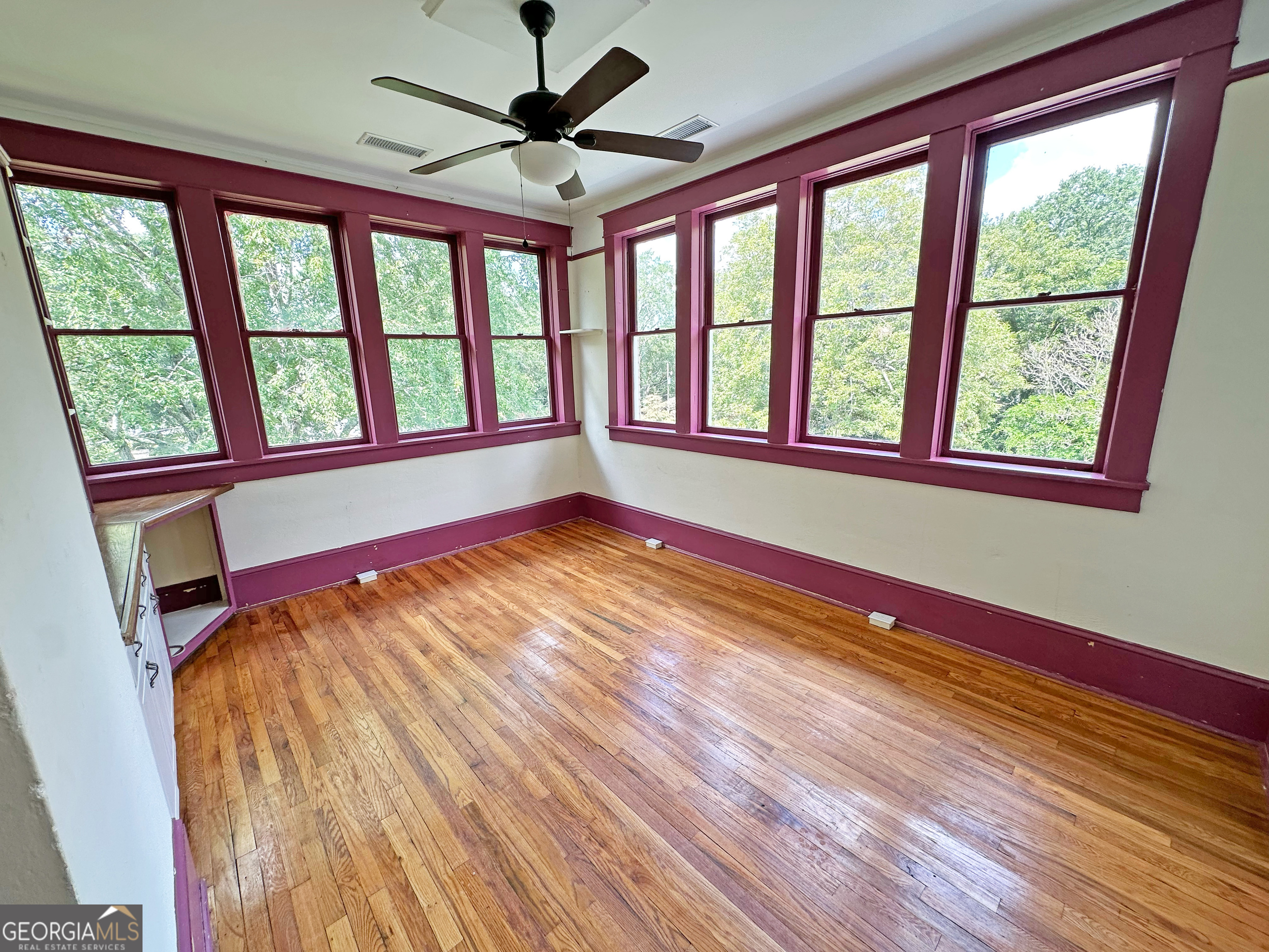 1010 Oglethorpe Avenue Athens, GA 30606 - Photo 24 of 28 a view of an empty room with a window and wooden floor
