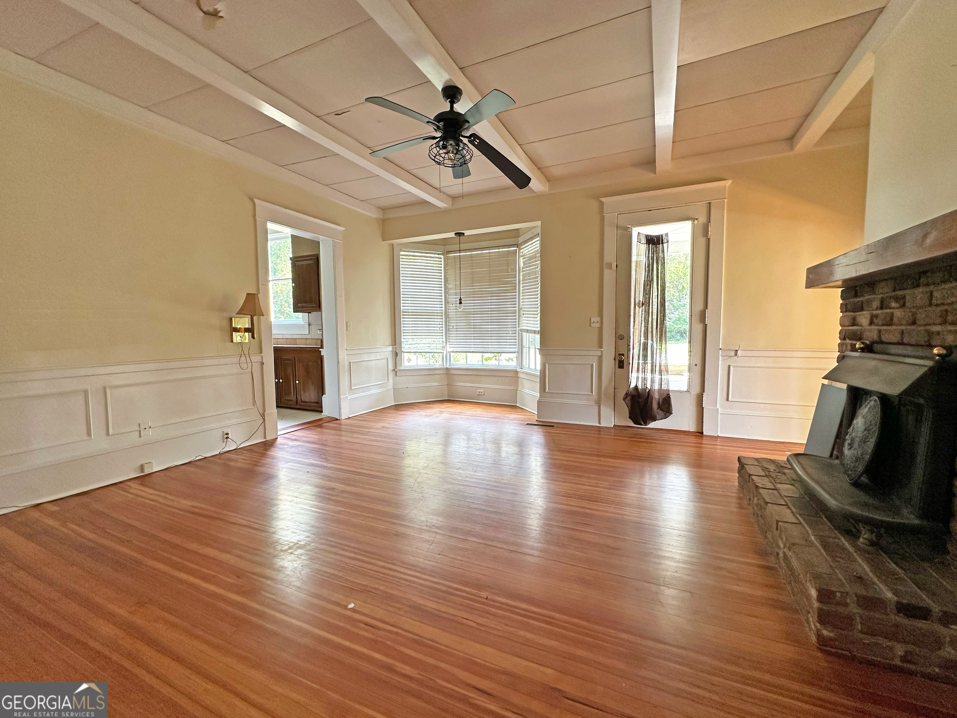 1010 Oglethorpe Avenue Athens, GA 30606 - Photo 9 of 28 a view of empty room with wooden floor and fireplace