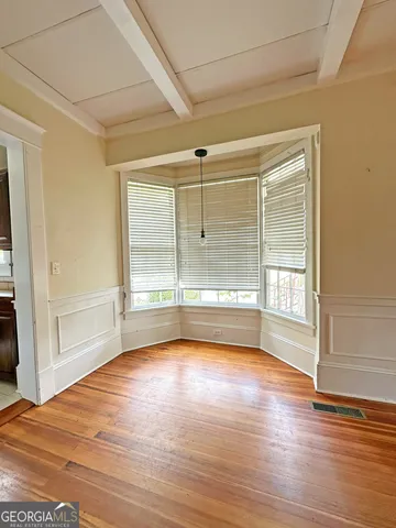 a view of a room with wooden floor and windows