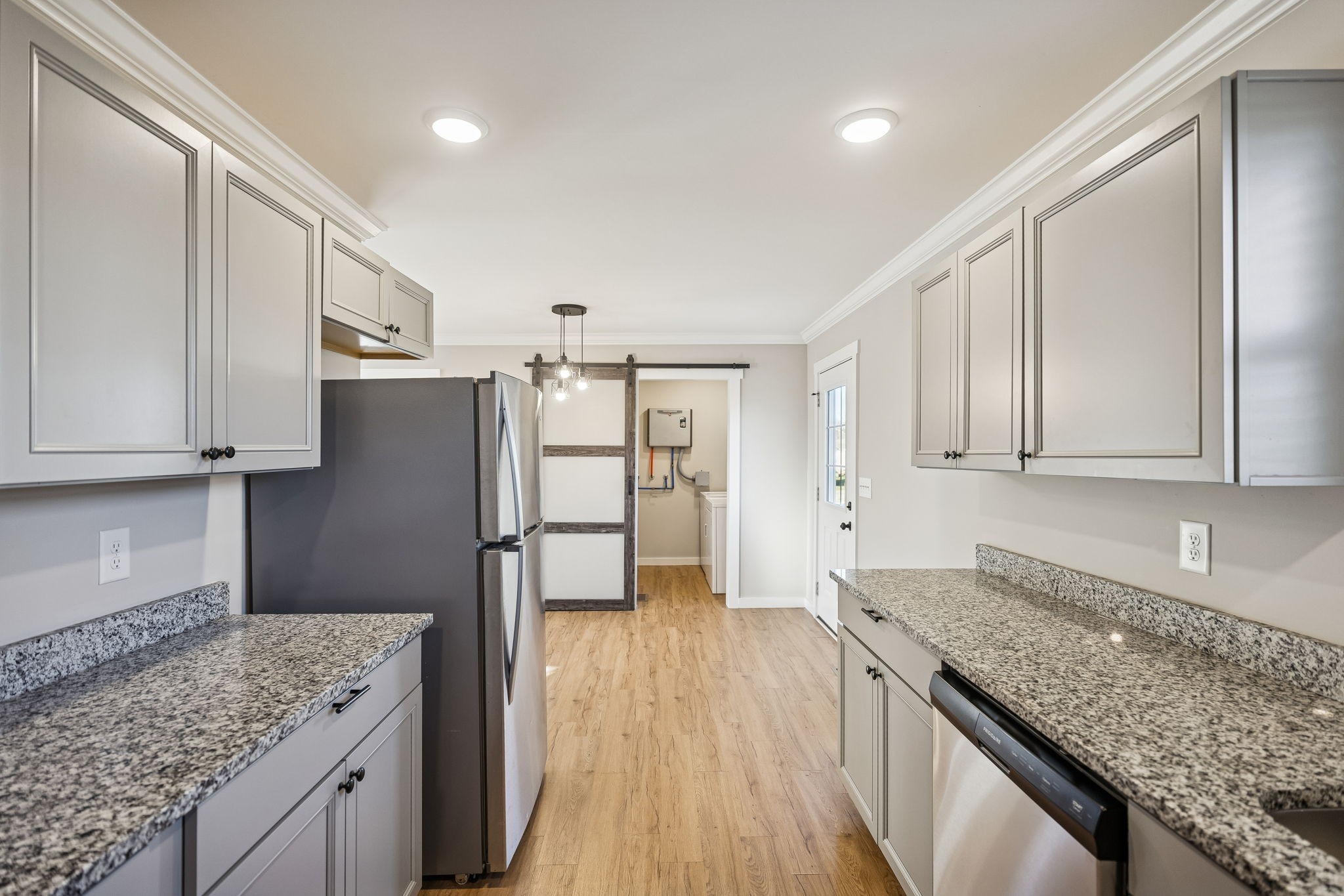3770 Penile Hill Road Decherd, TN 37324 - Photo 7 of 32 a kitchen with stainless steel appliances granite countertop a refrigerator a sink dishwasher and white cabinets with wooden floor