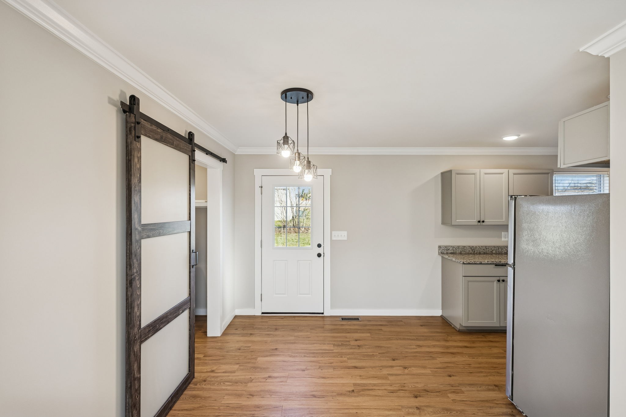 3770 Penile Hill Road Decherd, TN 37324 - Photo 9 of 32 a view of a kitchen with refrigerator and wooden floor