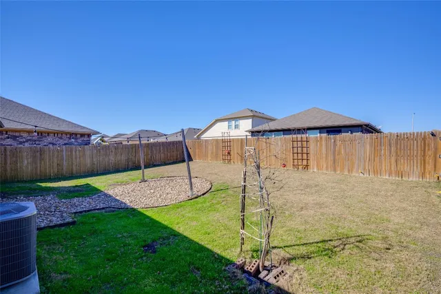 a view of a house with a patio and a yard