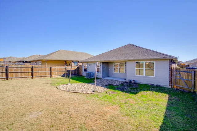 a view of a garden with a house in the background