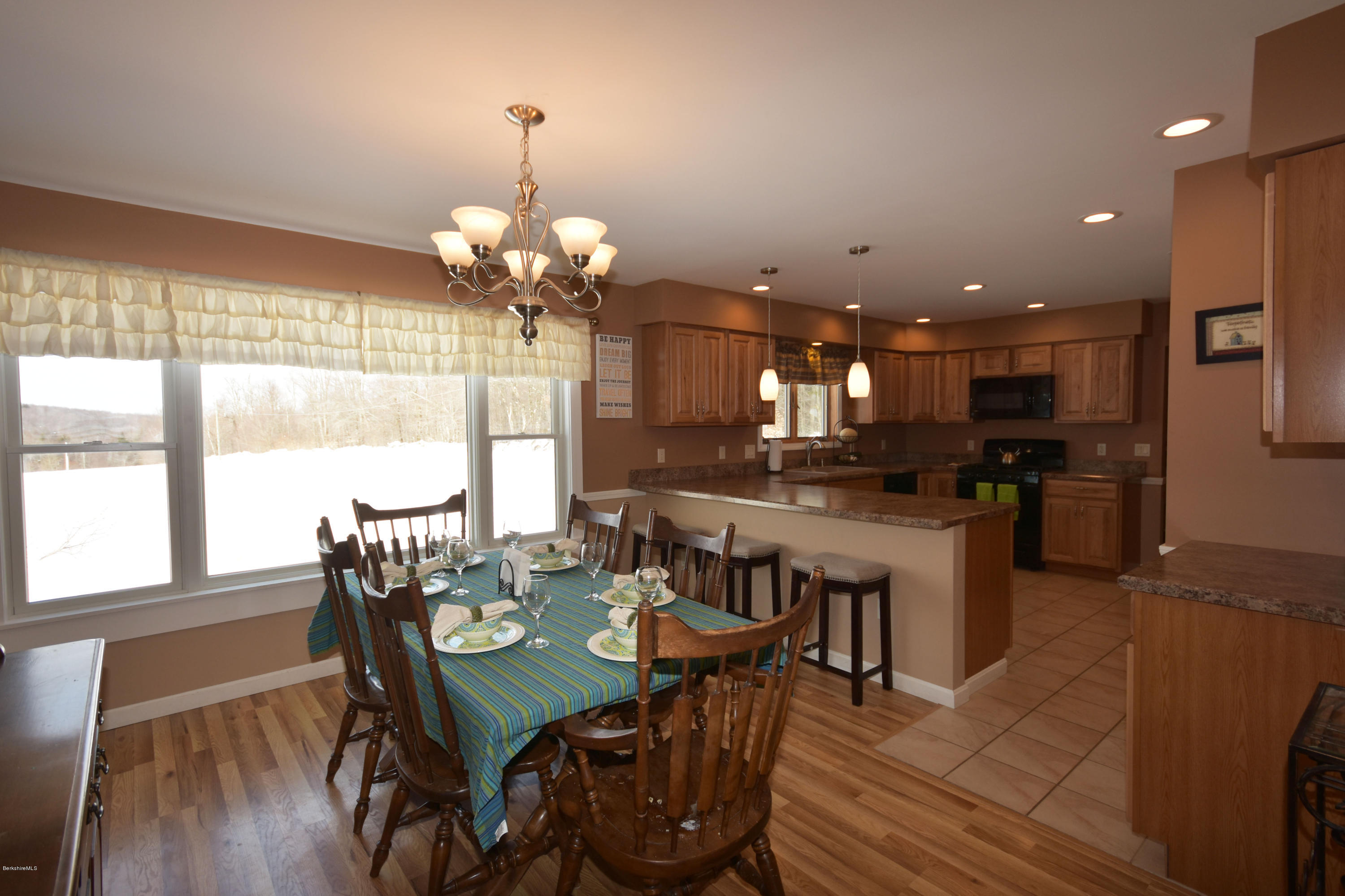 215 Windsor Road Savoy, MA 01256 - Photo 12 of 55 a view of a dining room and livingroom with furniture wooden floor a chandelier