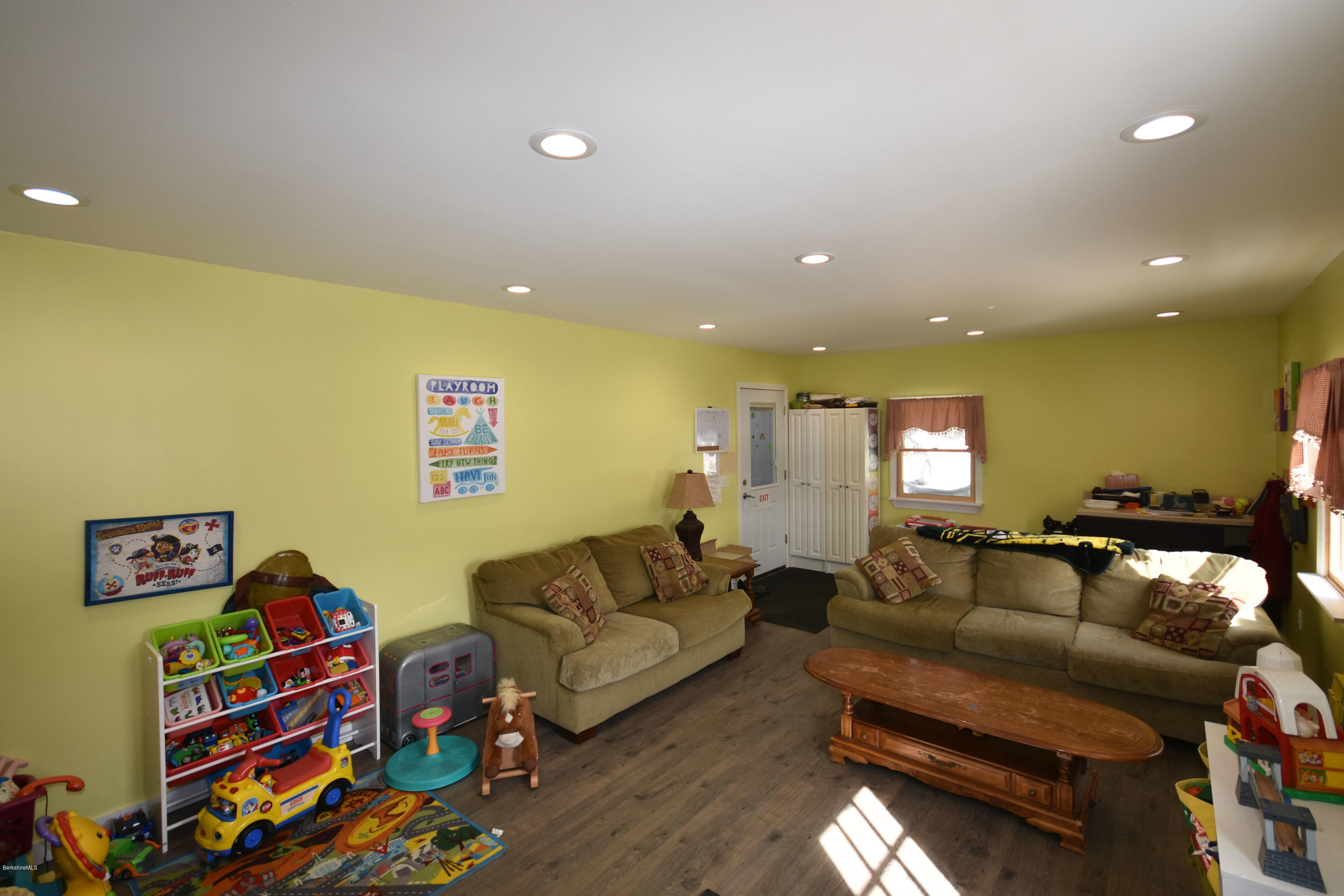 215 Windsor Road Savoy, MA 01256 - Photo 23 of 55 a living room with furniture and a bookshelf with wooden floor