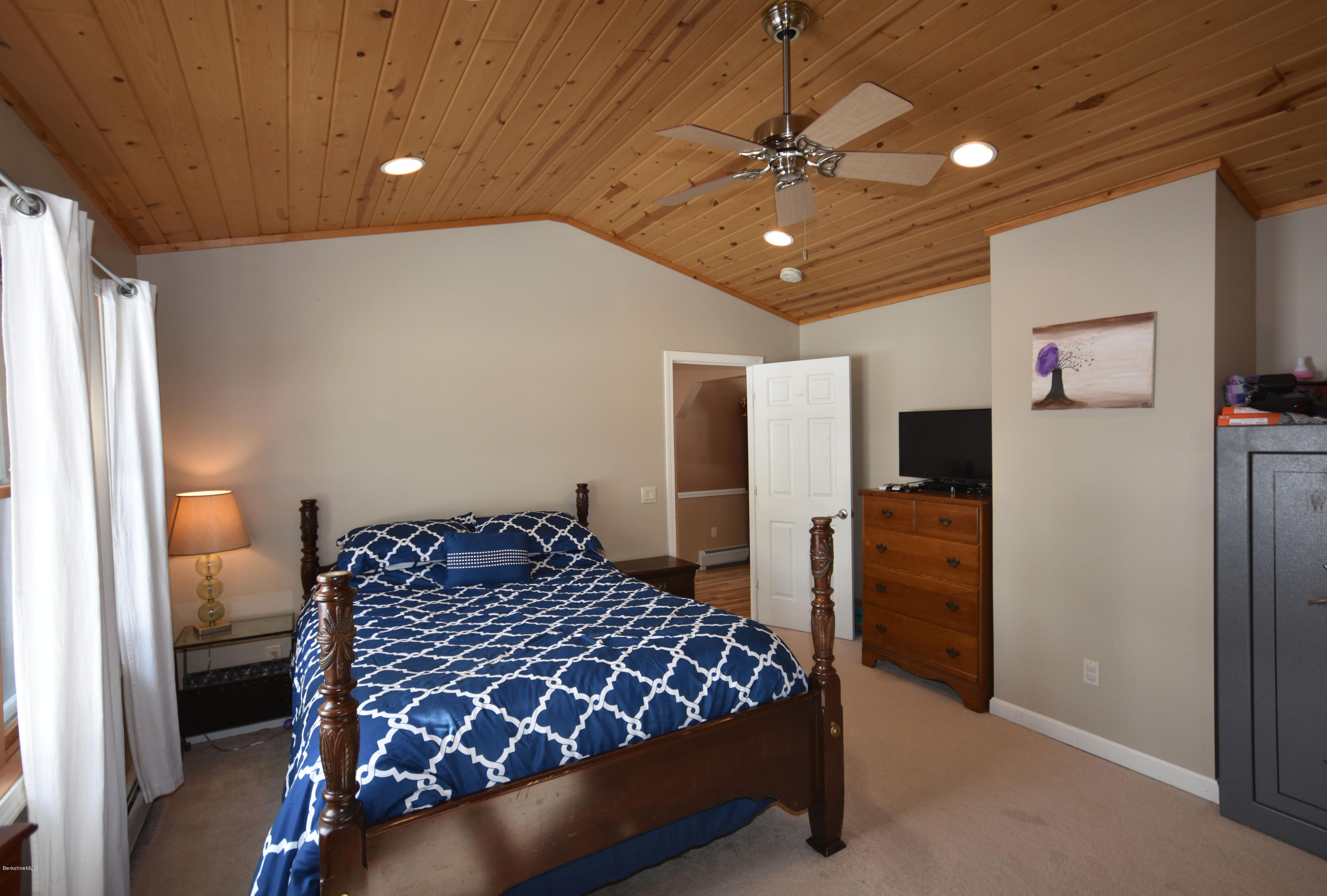 215 Windsor Road Savoy, MA 01256 - Photo 26 of 55 a bedroom with a bed and a chandelier