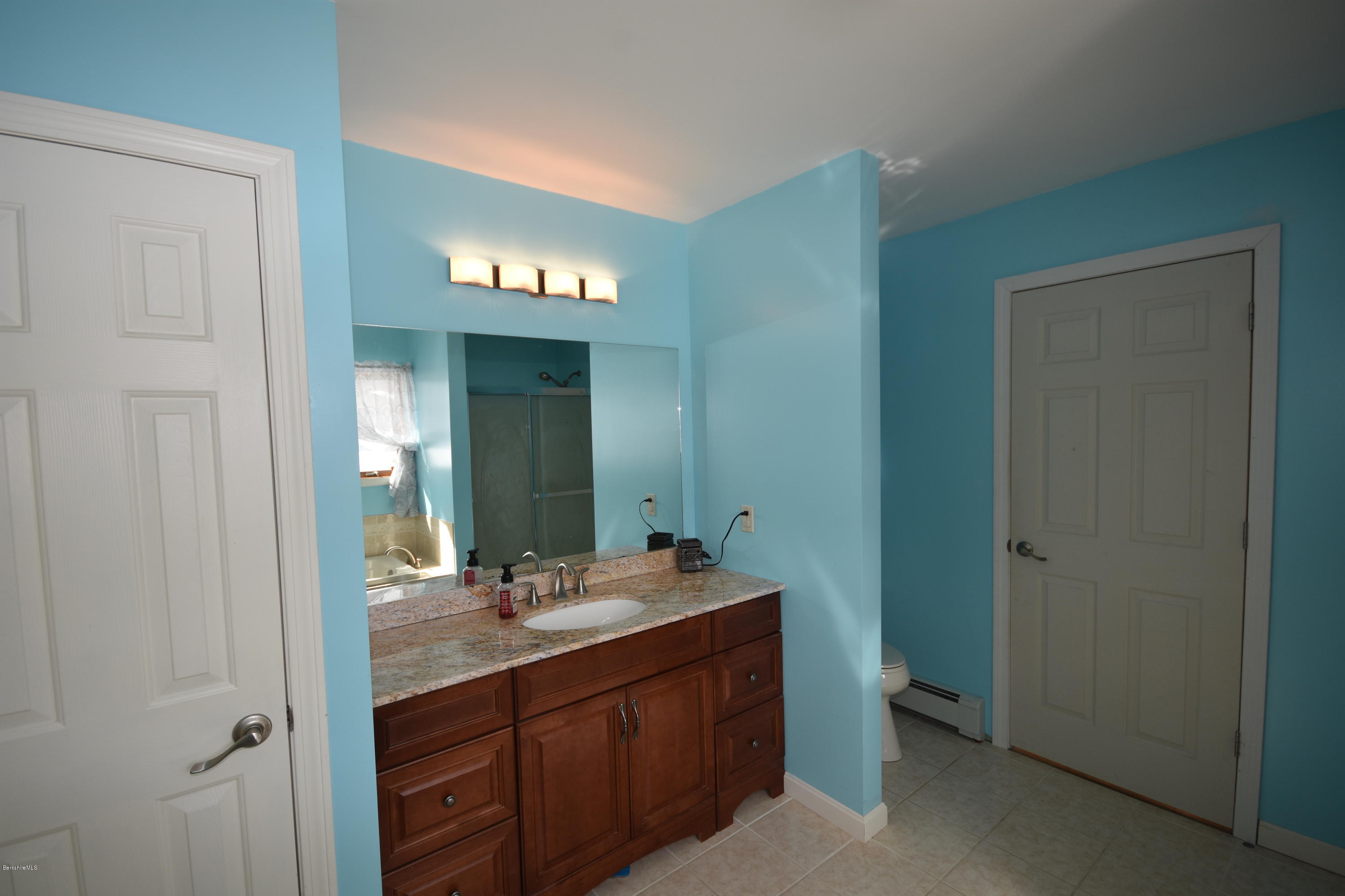 215 Windsor Road Savoy, MA 01256 - Photo 28 of 55 a bathroom with a double vanity sink and a mirror