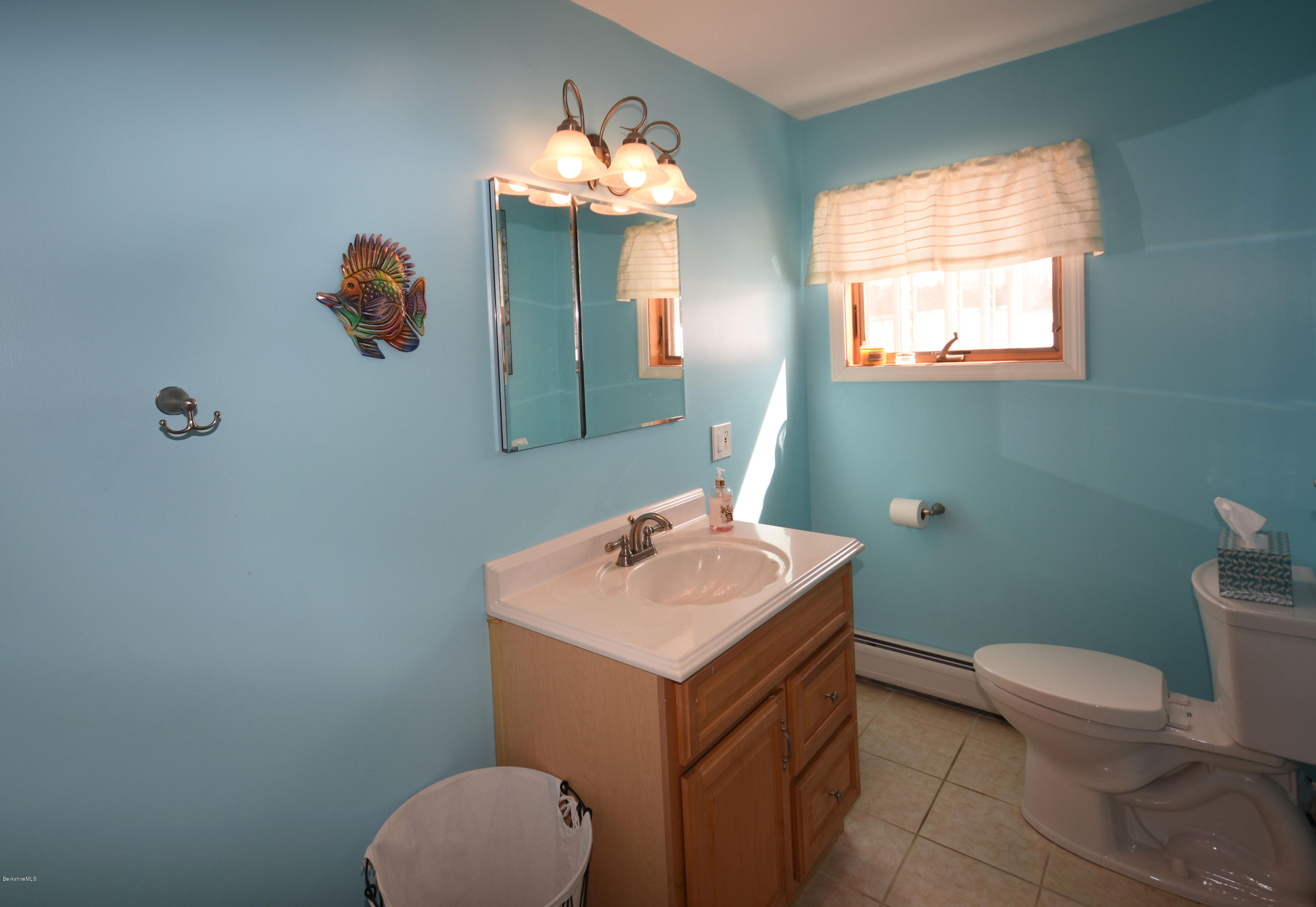 215 Windsor Road Savoy, MA 01256 - Photo 39 of 55 a bathroom with a toilet sink and mirror