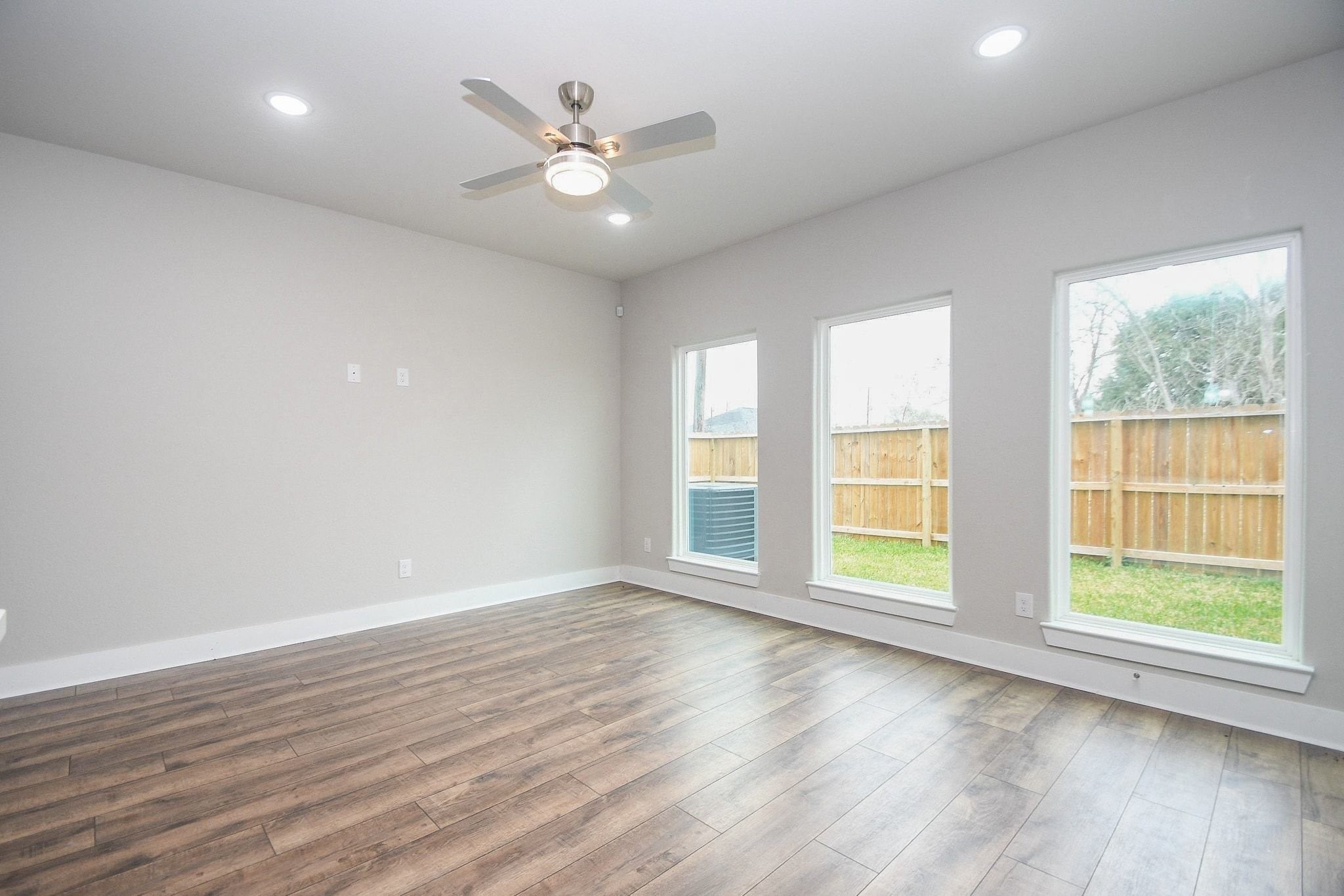 4401 Alvin Street, Unit A Houston, TX 77051 - Photo 7 of 19 an empty room with wooden floor and windows