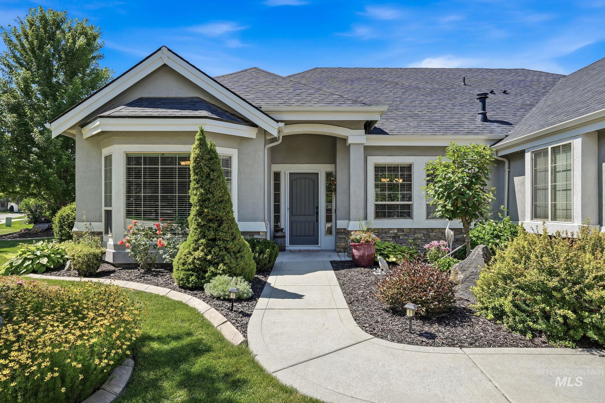 3969 North Hollymount Way Meridian, ID 83646 - Photo 3 of 47 Inviting stucco exterior with stone accents, a dark shingle roof, and a prominent bay window