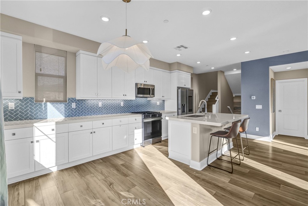 31861 Williams Way Rancho Mission Viejo, CA 92694 - Photo 8 of 28 a kitchen with kitchen island granite countertop a sink cabinets and wooden floor