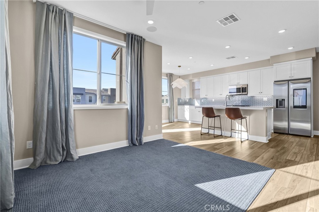 31861 Williams Way Rancho Mission Viejo, CA 92694 - Photo 10 of 28 a view of a kitchen with kitchen island a window a refrigerator and a sink