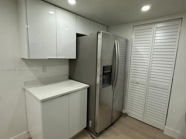 a kitchen with a sink and steel appliances