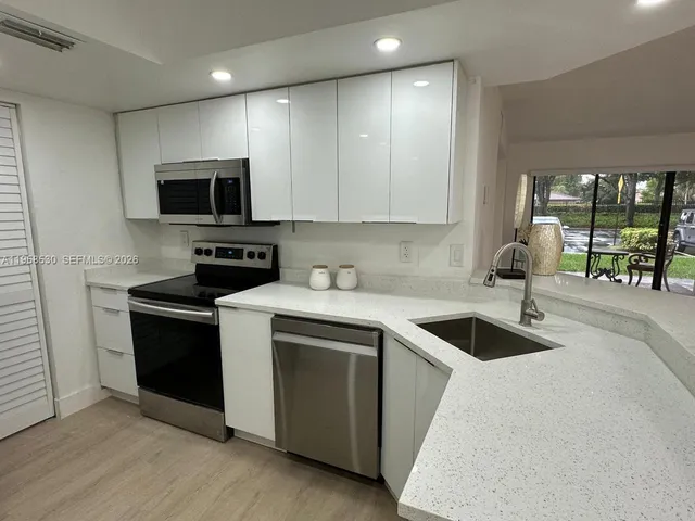 a kitchen that has a sink and a stove