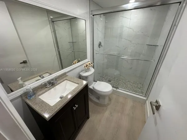 a bathroom with a sink toilet and shower
