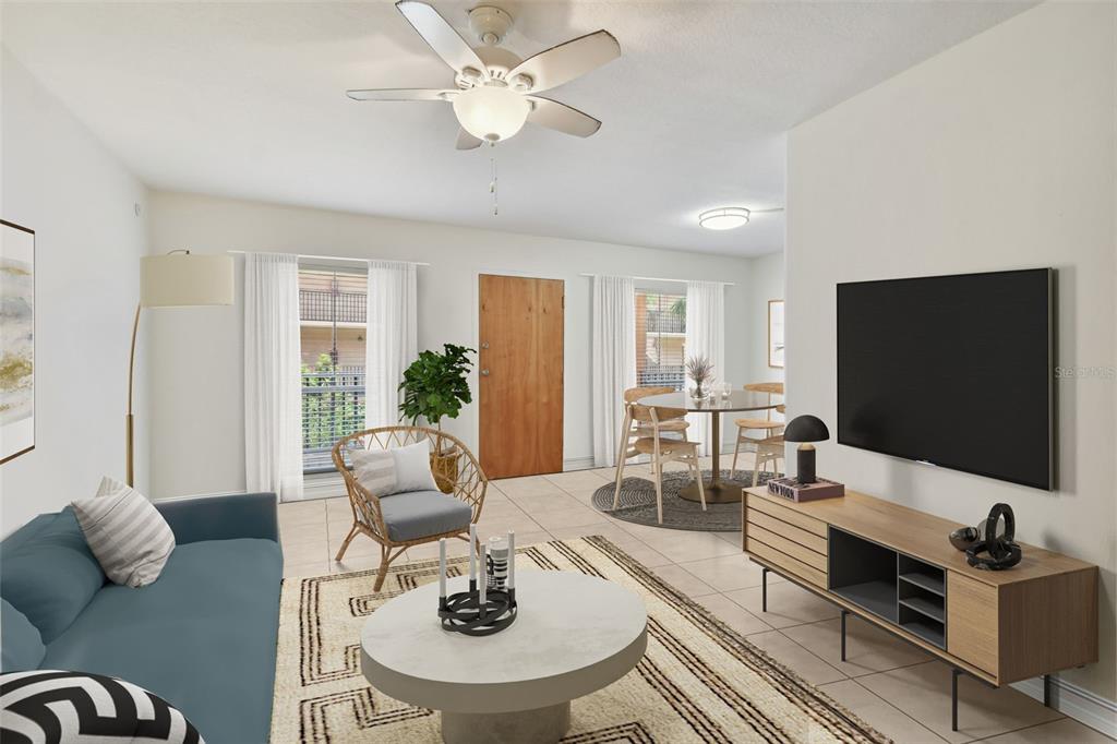 8931 Blind Pass Road, Unit 257 St. Pete Beach, FL 33706 - Photo 3 of 10 a living room with furniture and a flat screen tv