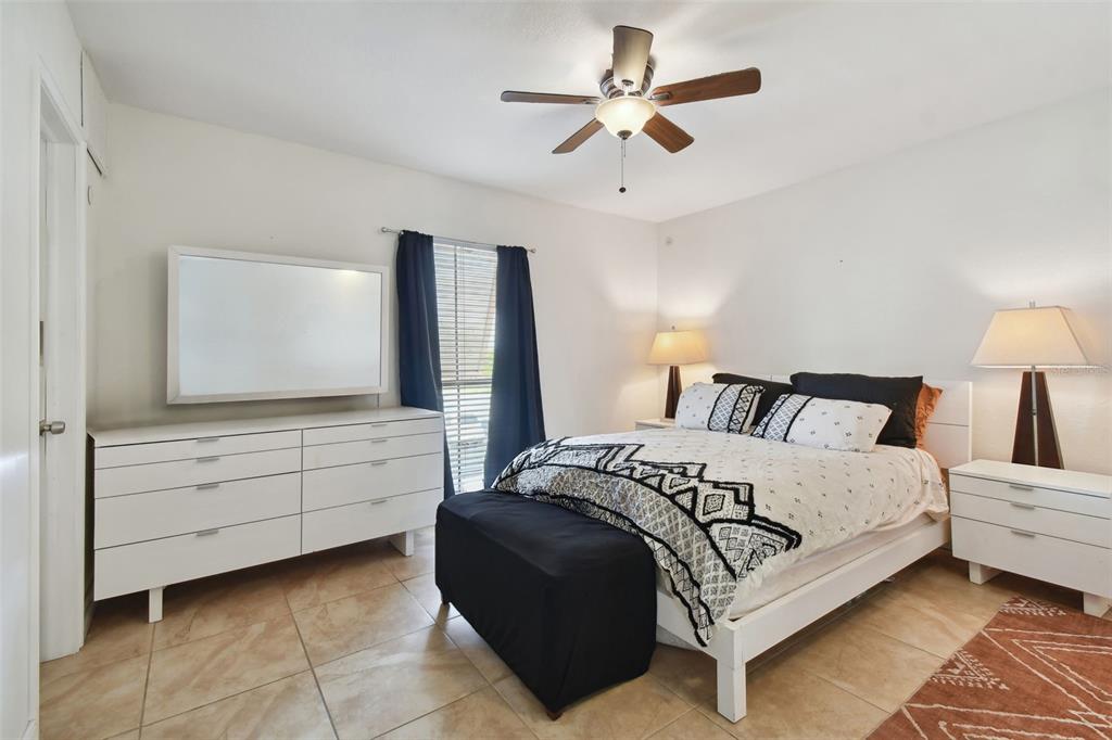 8931 Blind Pass Road, Unit 257 St. Pete Beach, FL 33706 - Photo 6 of 10 a bedroom with a large bed and a flat tv screen on dresser