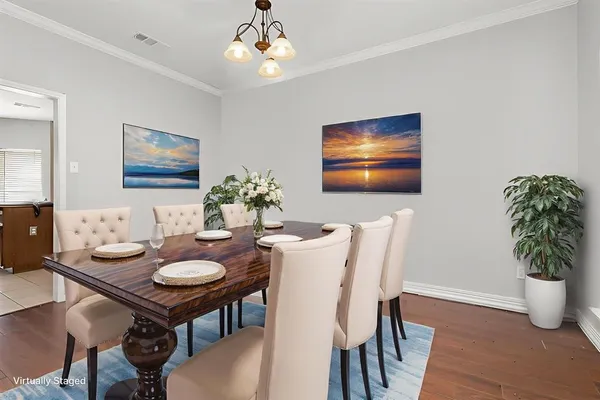 a view of a dining room with furniture wooden floor and a chandelier
