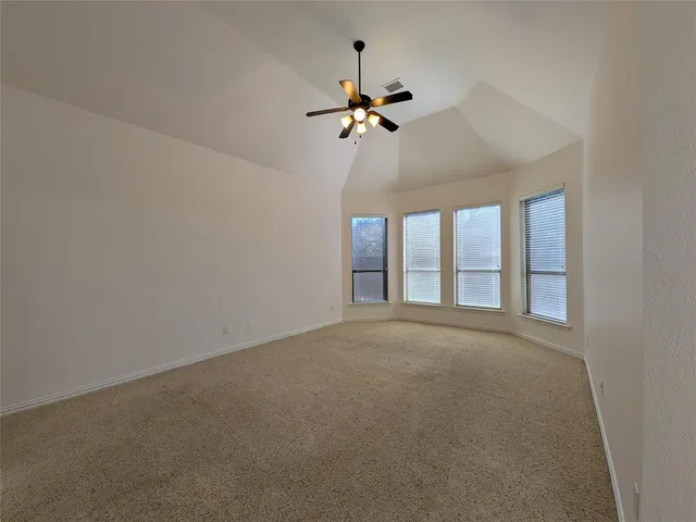 a view of a livingroom with a ceiling fan and window