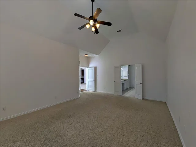 a view of a livingroom with a ceiling fan and window
