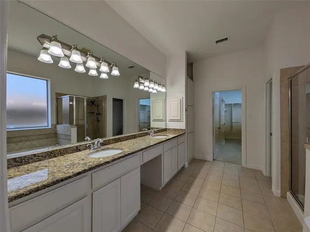 a large bathroom with a sink and a large mirror