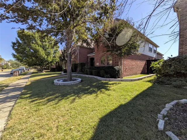 a view of a yard with large trees