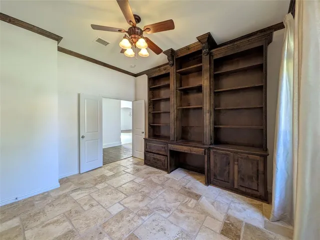a view of walk in closet with empty racks
