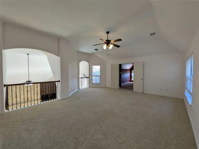 a view of a livingroom with a ceiling fan and window