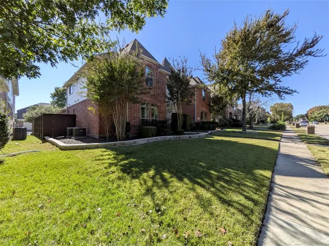 a view of a garden with a house