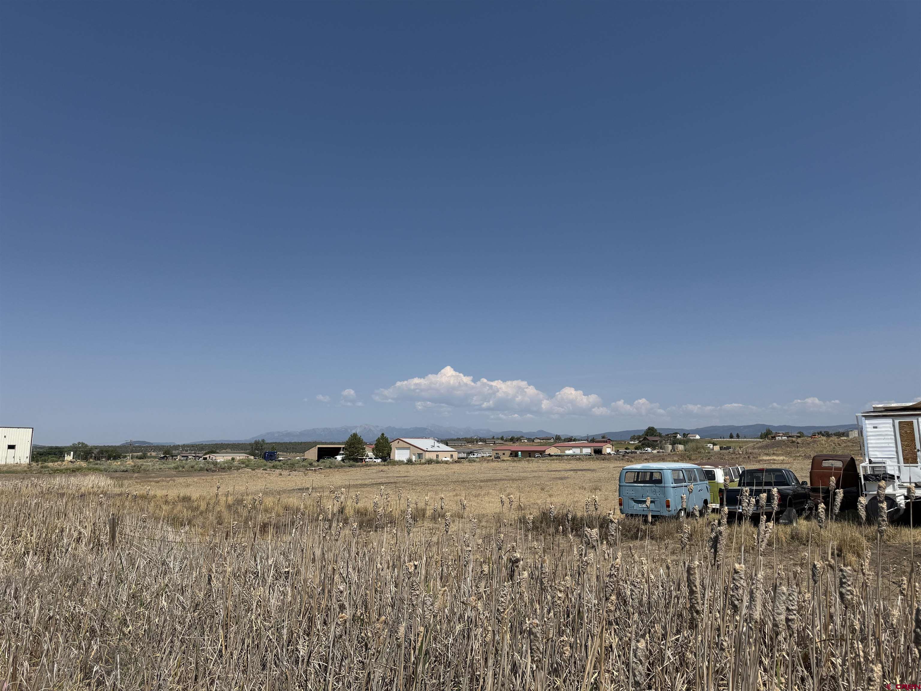 104 Chicken Hawk Lane Ignacio, CO 81137 - Photo 16 of 29 a view of an ocean with a building and trees in the background