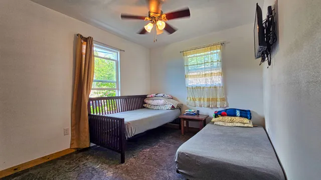 a bedroom with bed and window