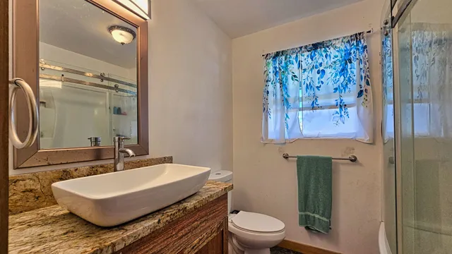 a bathroom with a sink toilet and shower