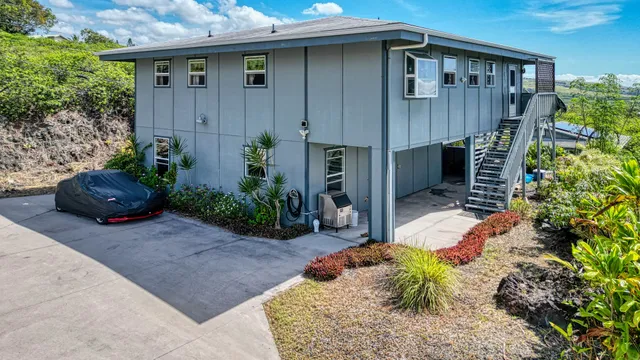 a view of a house with potted plants in front of door