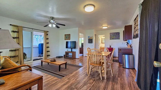 a living room with furniture and wooden floor